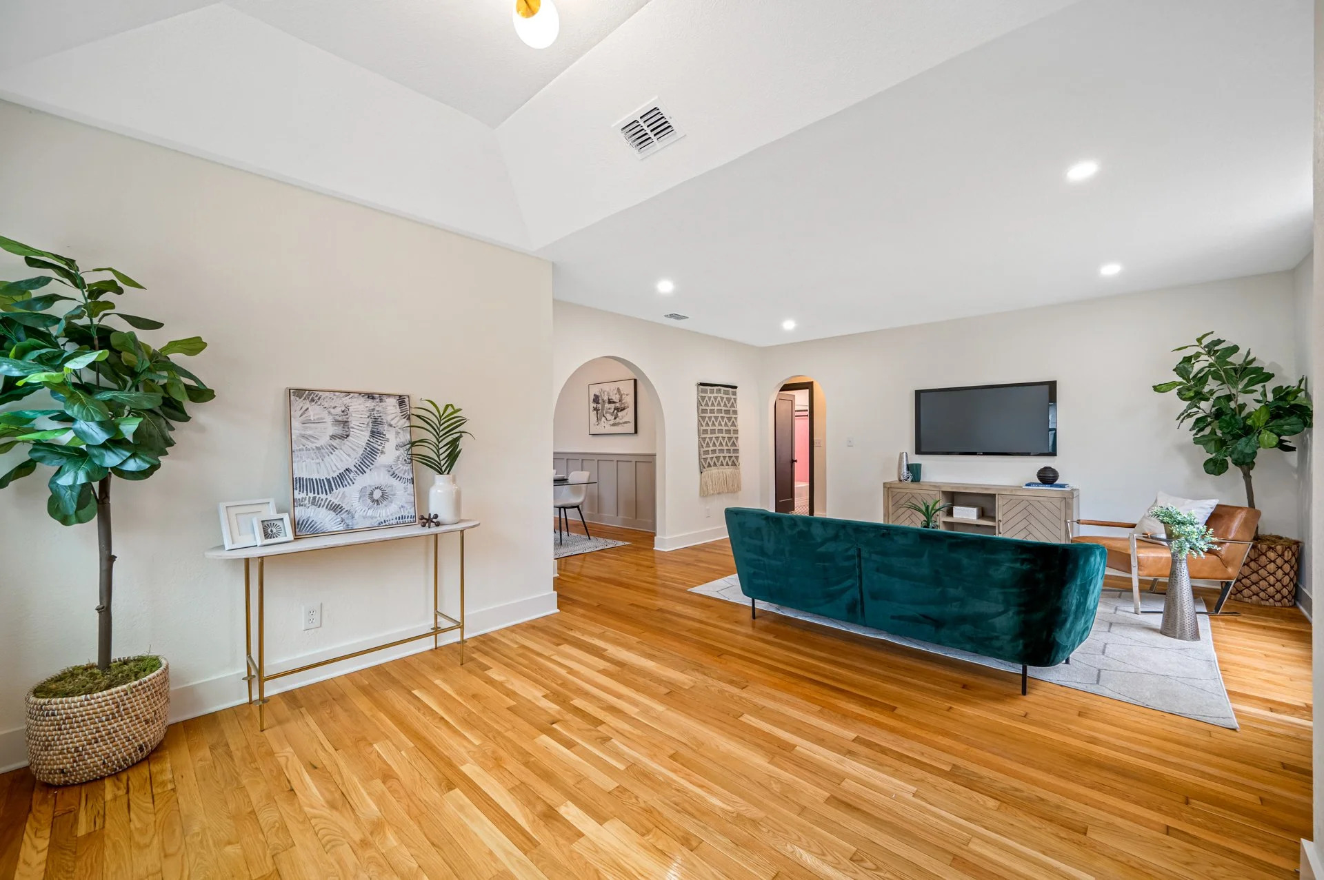 Renovated Tampa bungalow living room with hardwood floors and arched doorways