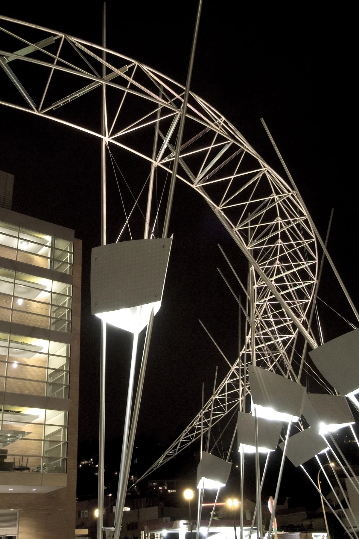 Tecotosh art installation — illuminated steel lattice sculpture at night