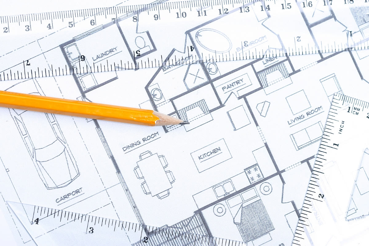 Residential floor plans with drafting pencil and scale ruler