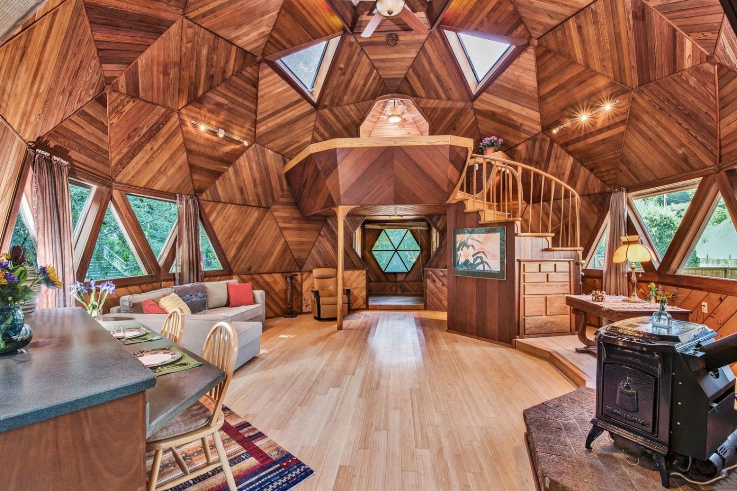 Geodesic dome home interior — wood-clad triangular panels and skylights