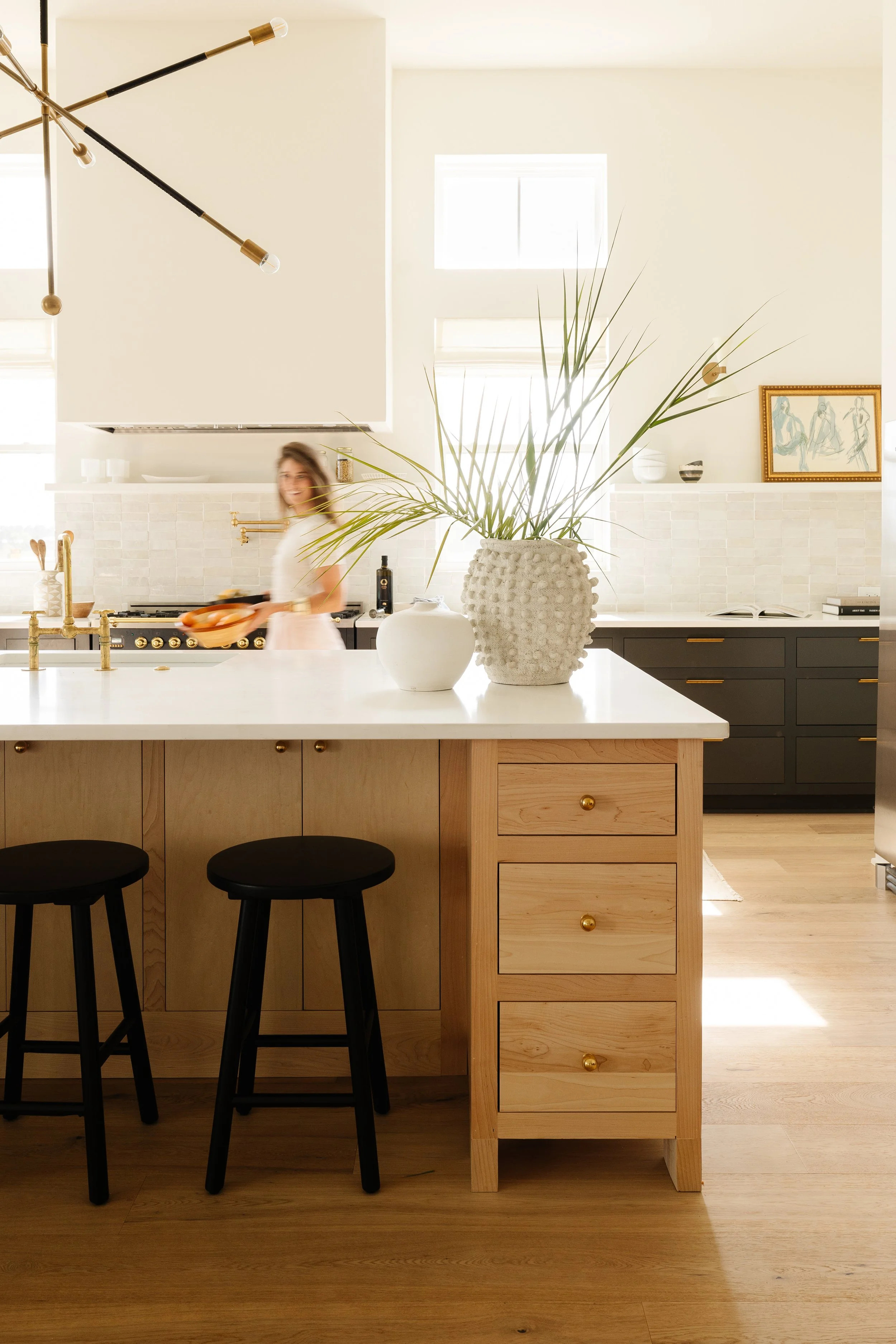 Lauren Riddei in a healthy kitchen she designed — natural wood, zellige tile