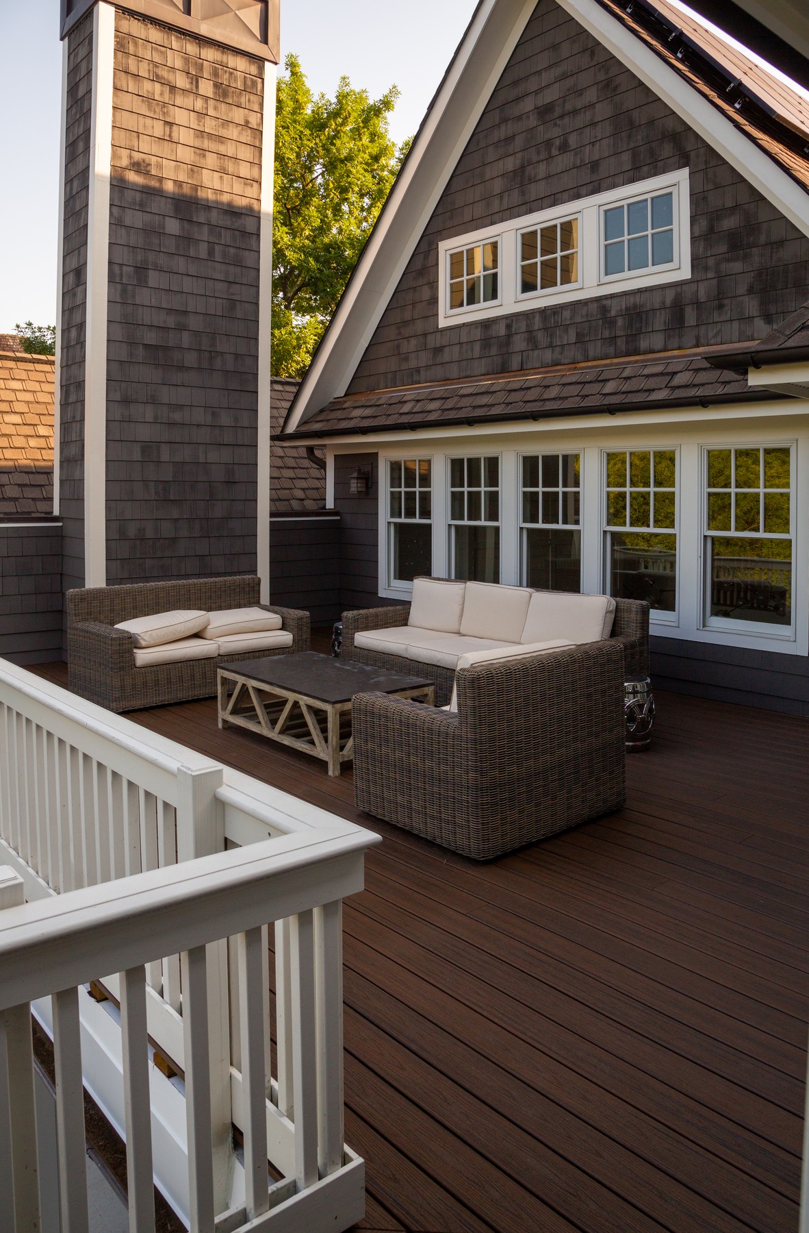 Craftsman home exterior with composite deck and rattan seating