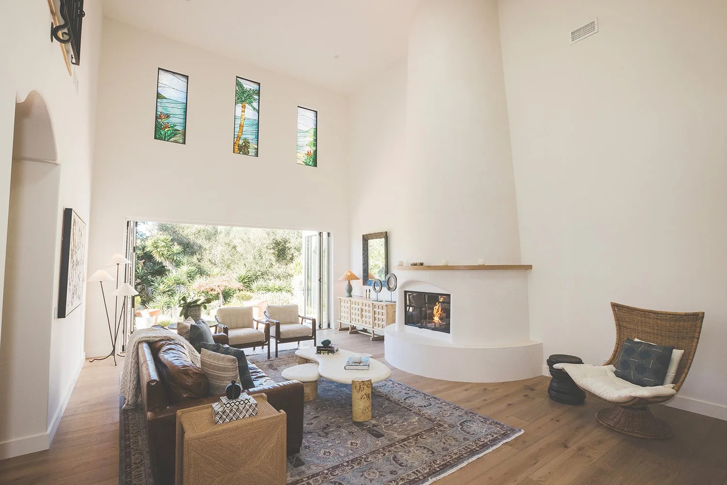Spanish-style living room with stained glass, vaulted ceiling, and fireplace in Santa Barbara, CA