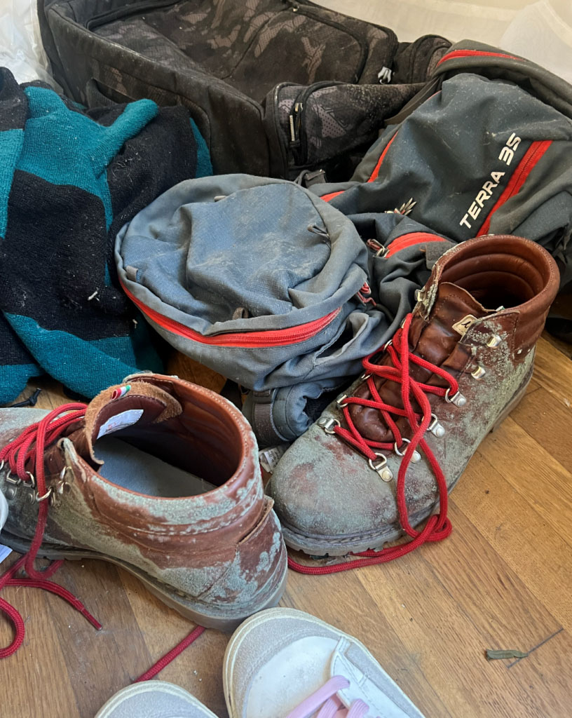 Outdoor shoes, clothing, and gear shown together