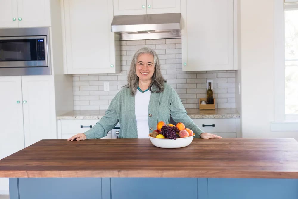 Karen Bloom — alternate portrait in a sage-toned kitchen