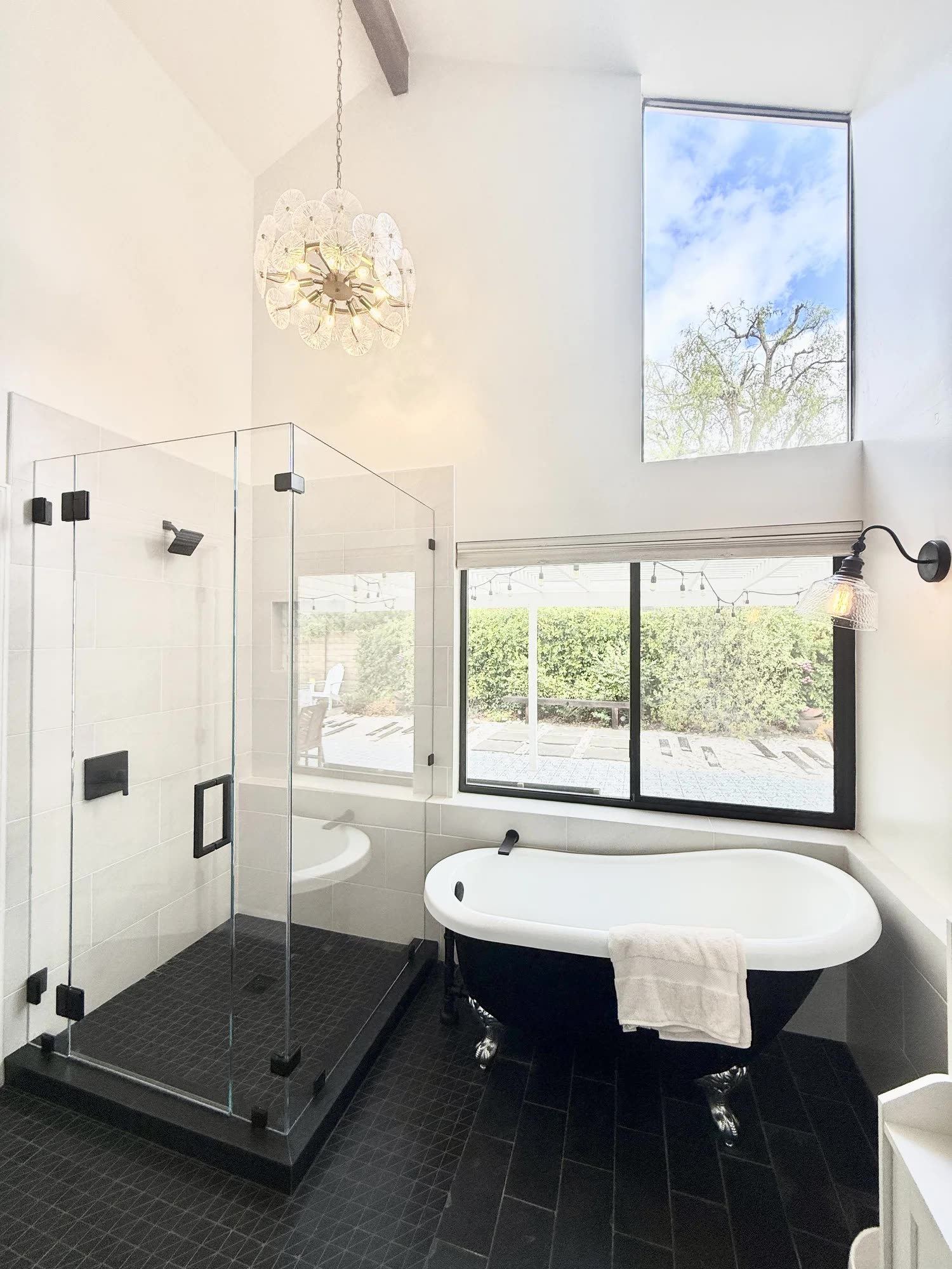 Editorial master bathroom with freestanding soaking tub and slate floor