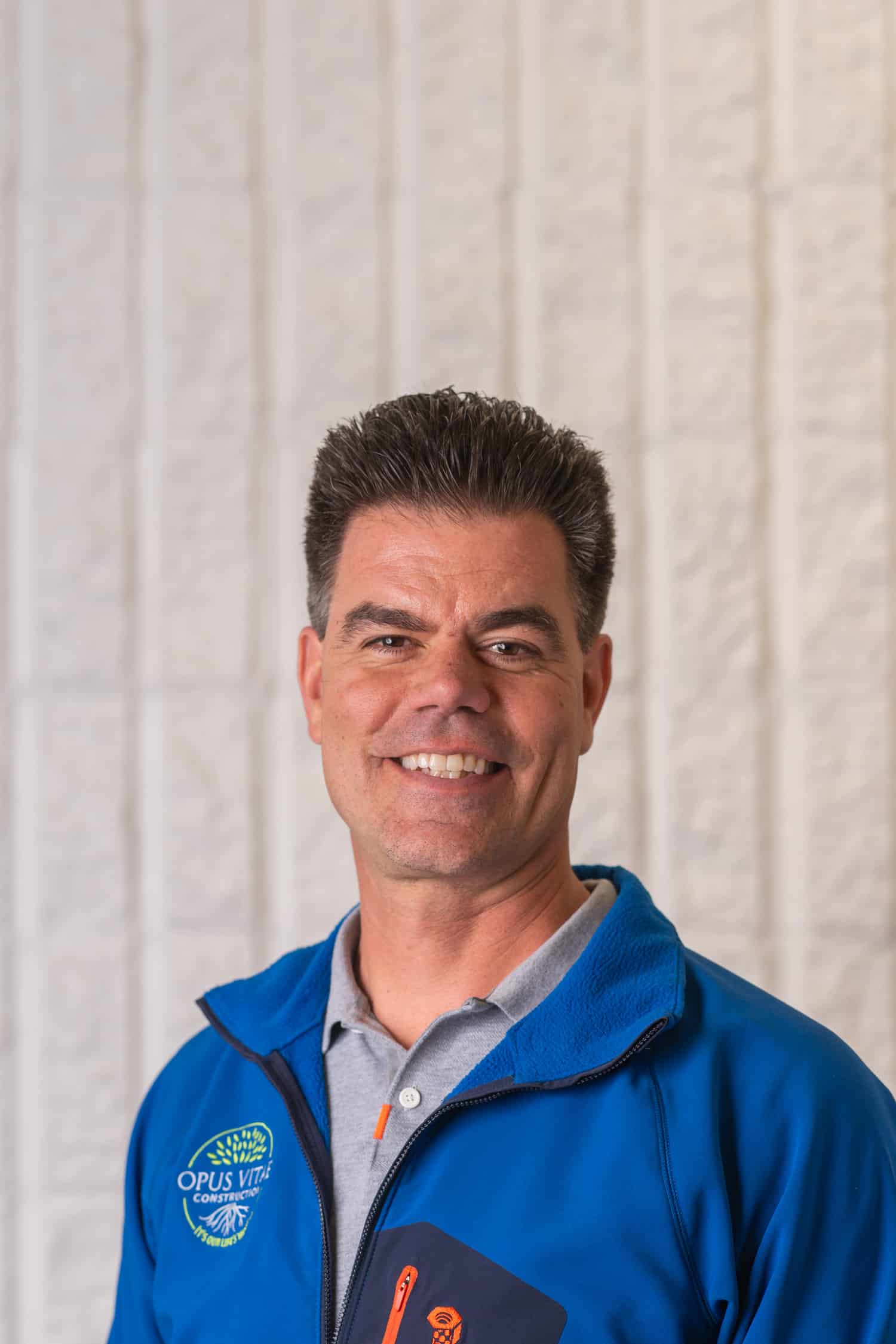 Kevin Rosa, co-founder of Opus Vitae Construction in an Opus Vitae jacket