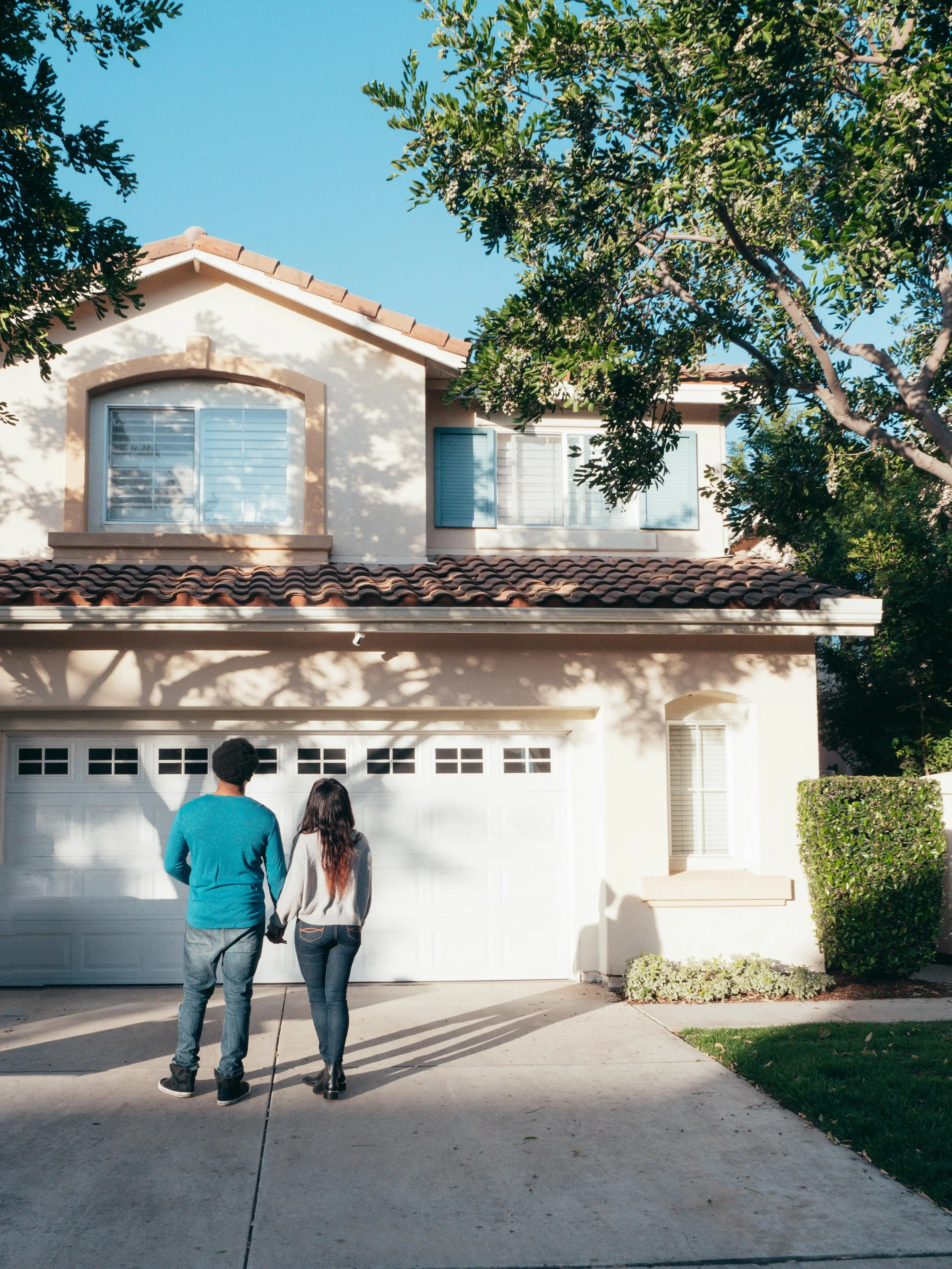 Couple standing before their home