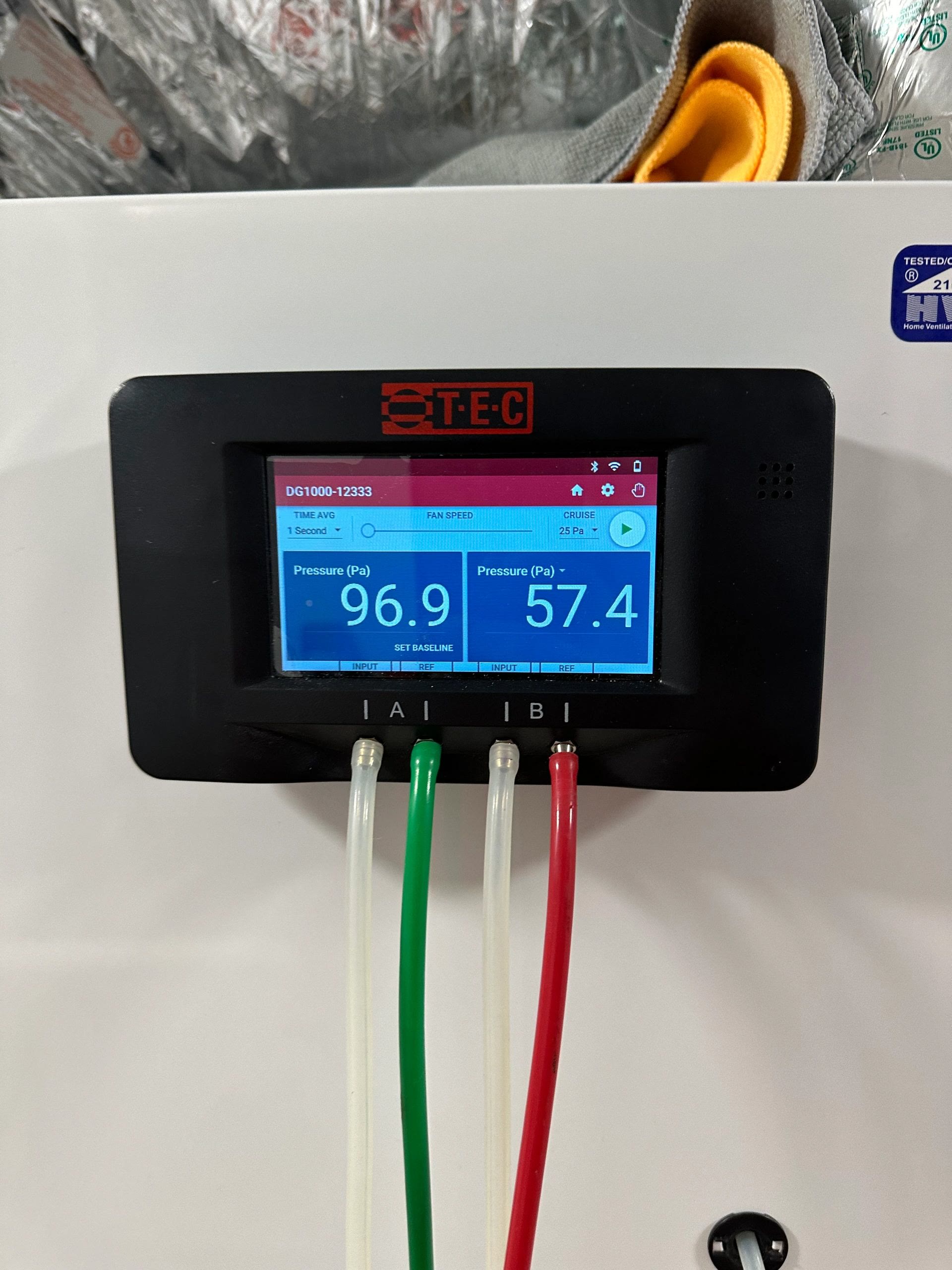 TEC DG-1000 pressure manometer showing 96.9 Pa and 57.4 Pa readings
