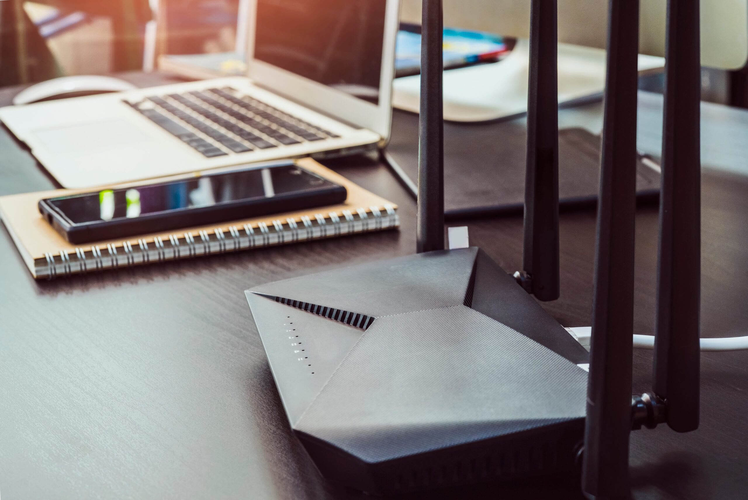 Home workstation with laptop, wifi router and multiple devices