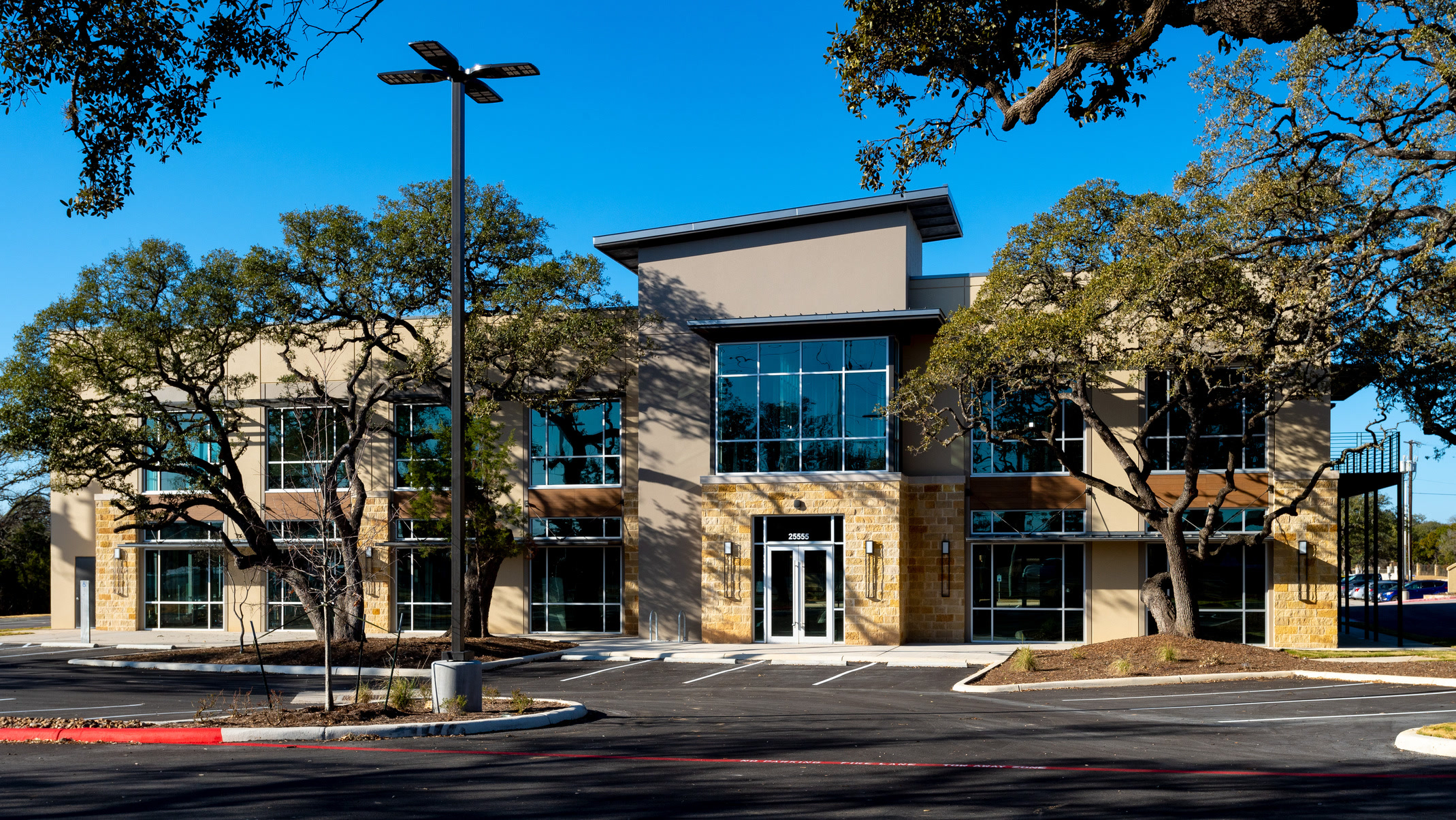 Modern medical office exterior at Two Creeks with warm evening lighting